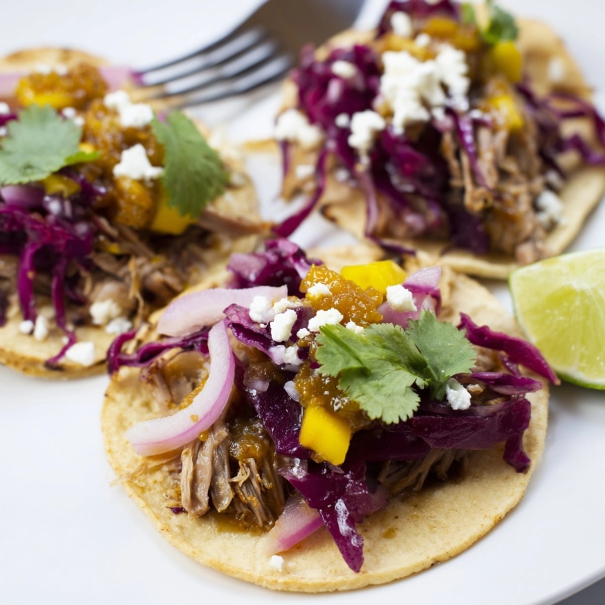 Close-up shot: Duck Confit Tacos with a delicious spicy mango chutney topping, ready to enjoy.