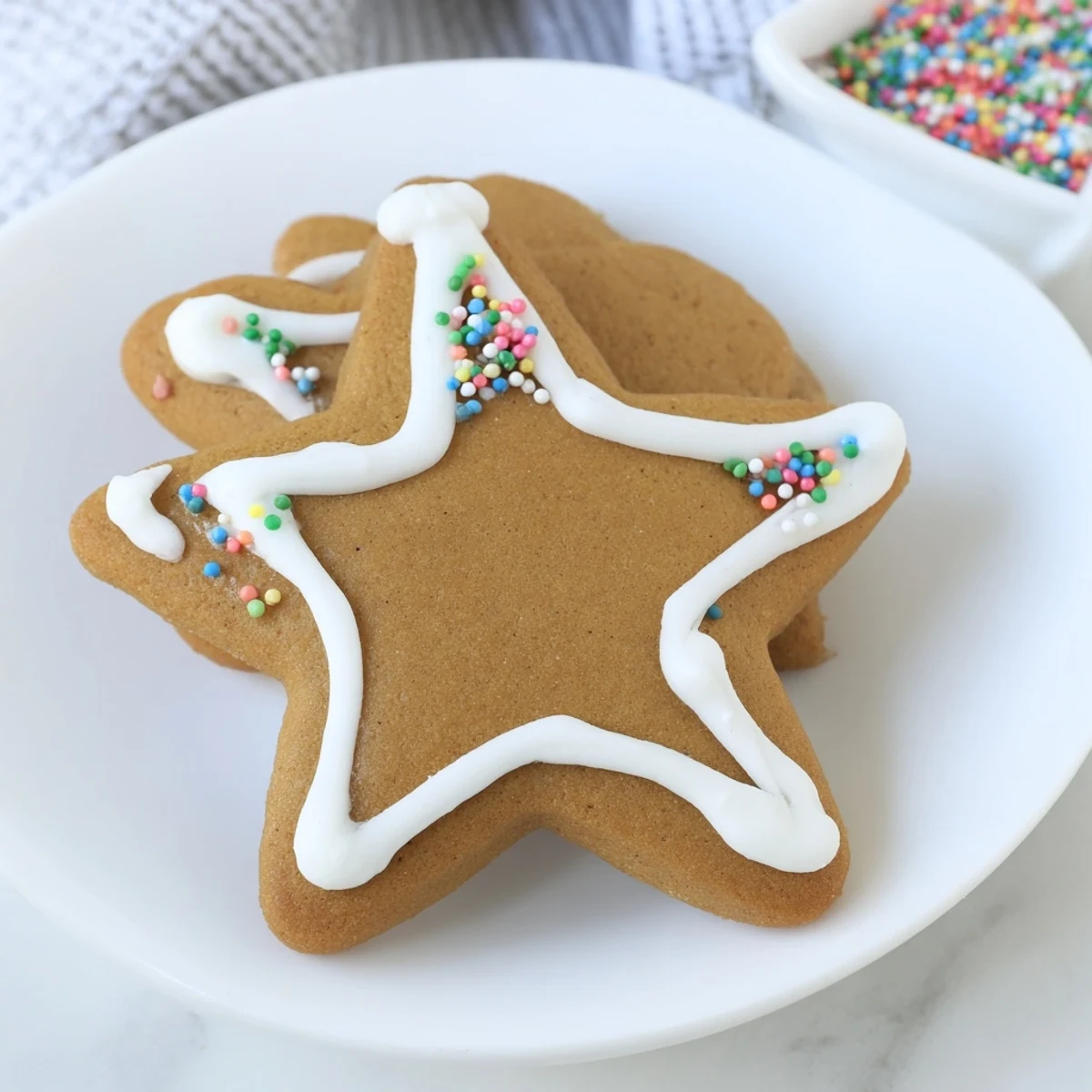 Beautifully decorated gingerbread ornaments, showcasing festive icing designs and shimmering sprinkles, ready to hang.