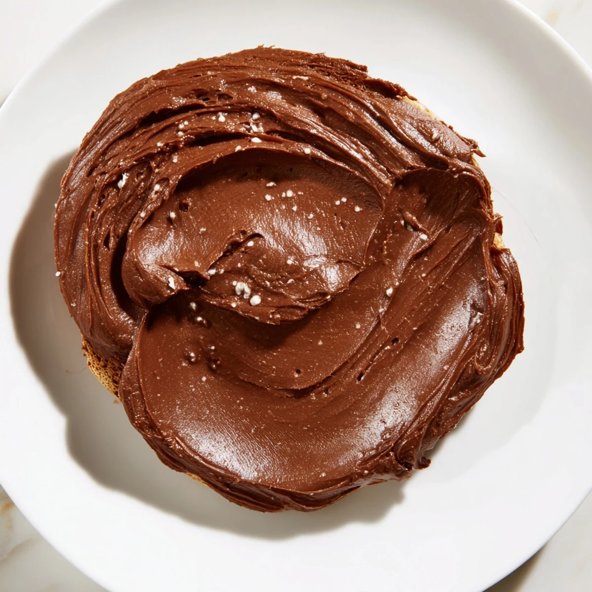 A jar of homemade chocolate spread, ready to be enjoyed as a fruit dip, looks decadent.