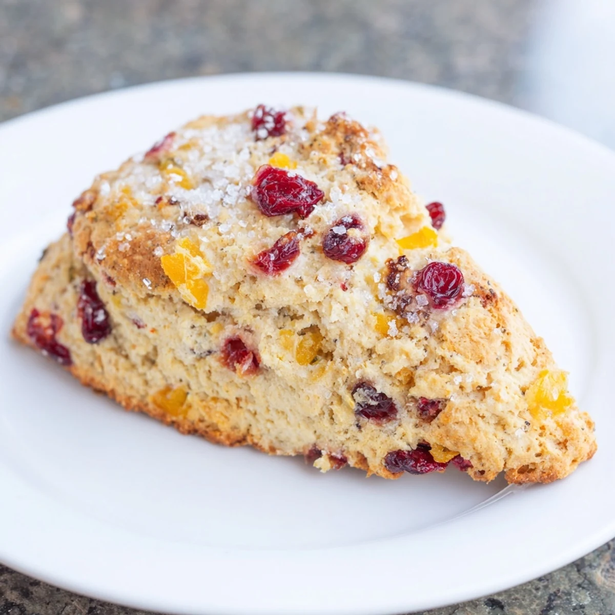 Fluffy cranberry orange scones, perfect for dunking into coffee, with visible cranberries and sugar topping.