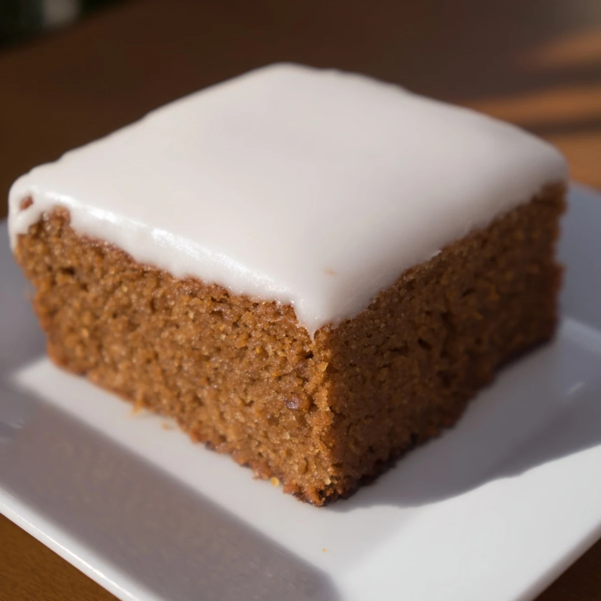 A square of iced gingerbread, boasting a crackled icing and inviting spiced aroma.