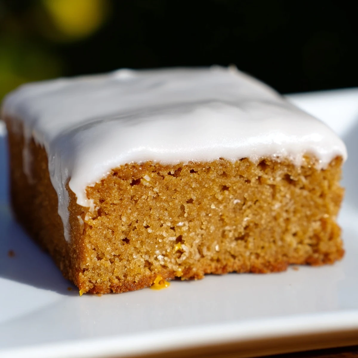 Warm molasses tones highlight the tender crumb of this homemade iced gingerbread treat.