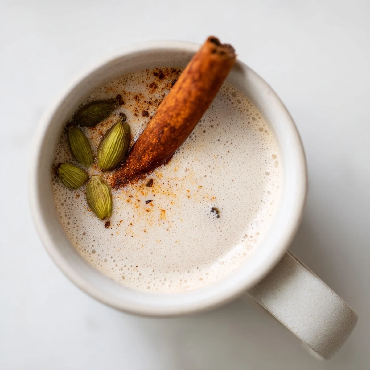 Richly aromatic spiced chai, brewed with fragrant spices, served in a ceramic mug, ready to sip.