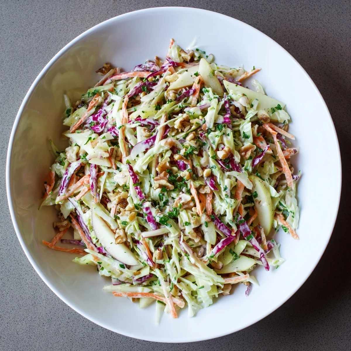 A creamy, colorful bowl of Winter Coleslaw with Apple, perfect as a fresh side dish.
