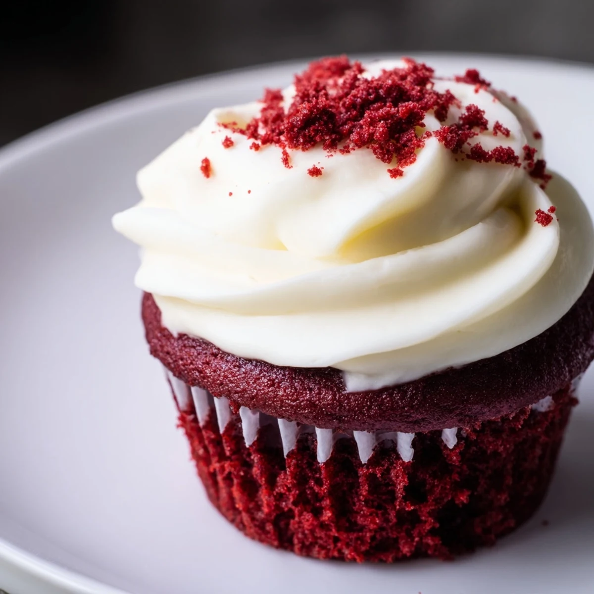 Fluffy red velvet cupcakes with creamy cream cheese frosting, perfect for a special treat.