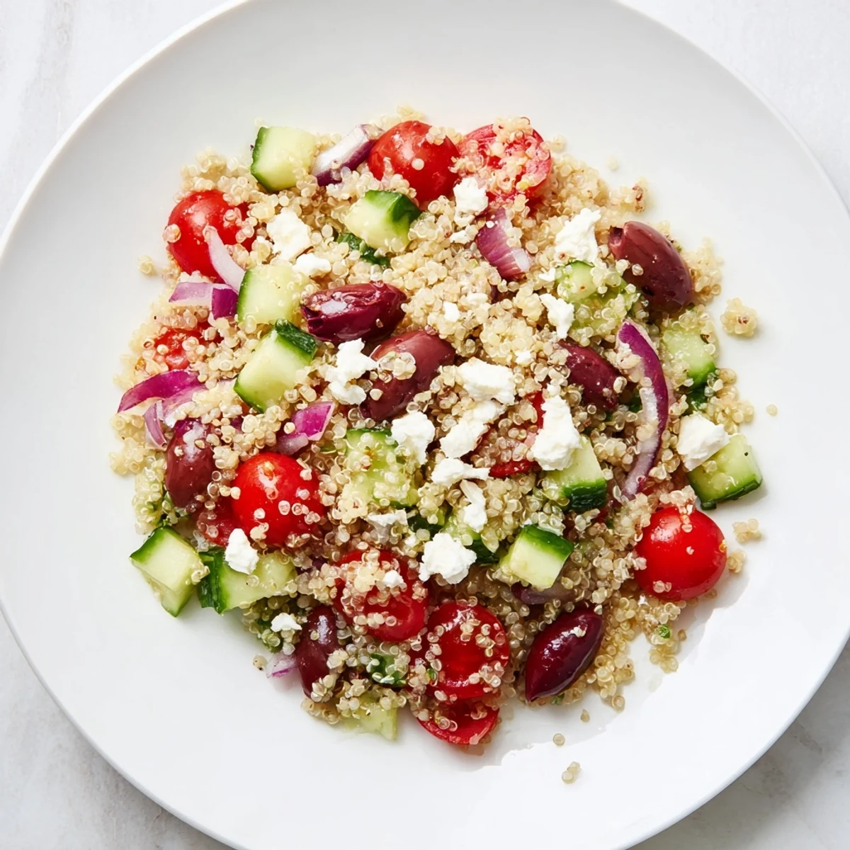 Freshly made Mediterranean Quinoa Salad with Cucumber, featuring vibrant colors and a tangy dressing.