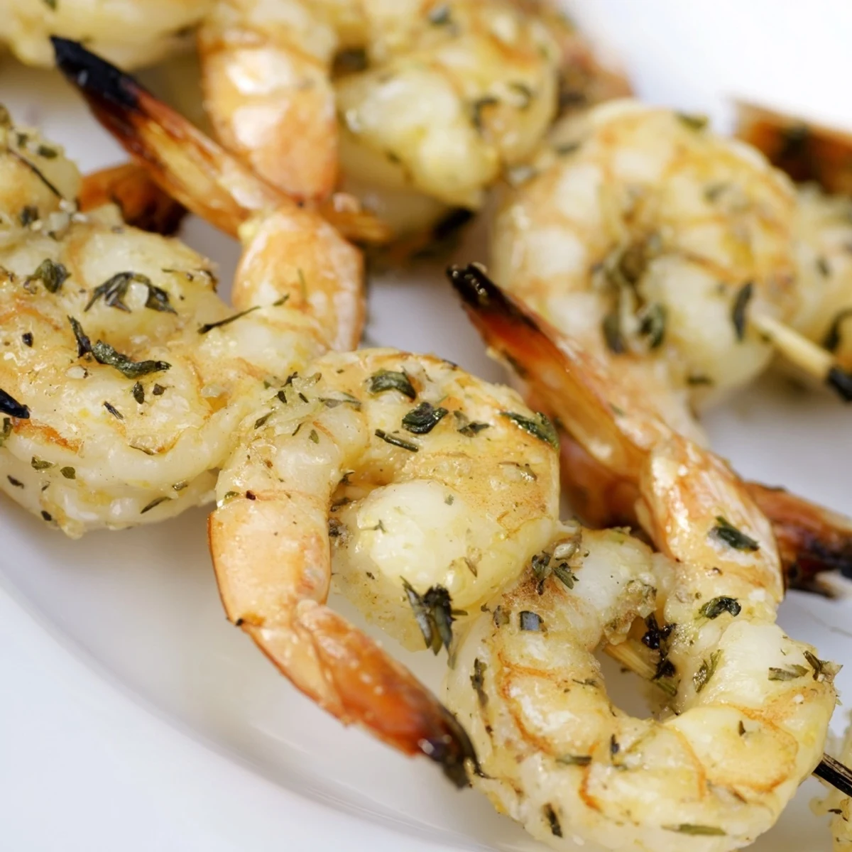 Platter of Lemon Herb Grilled Shrimp Skewers with aromatic herbs, ready to serve alongside grilled vegetables or a crisp salad.