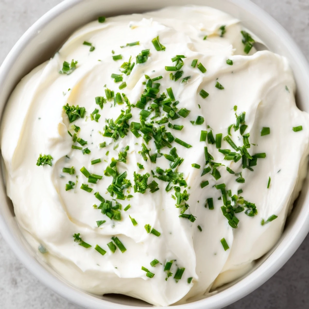 Creamy Snack Dip in a rustic bowl, surrounded by crunchy pita chips, carrot sticks, and celery for dipping. 