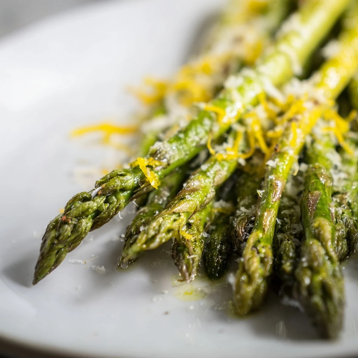 Golden roasted asparagus with Parmesan and lemon garnish, ready to serve alongside grilled chicken or fish for dinner.