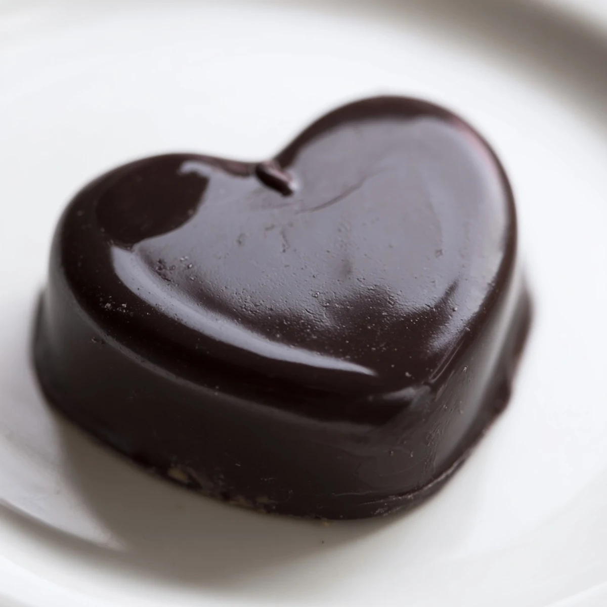 Homemade Chocolate Peanut Butter Hearts on a cooling rack, half coated in chocolate and half ready to dip for a DIY assembly.