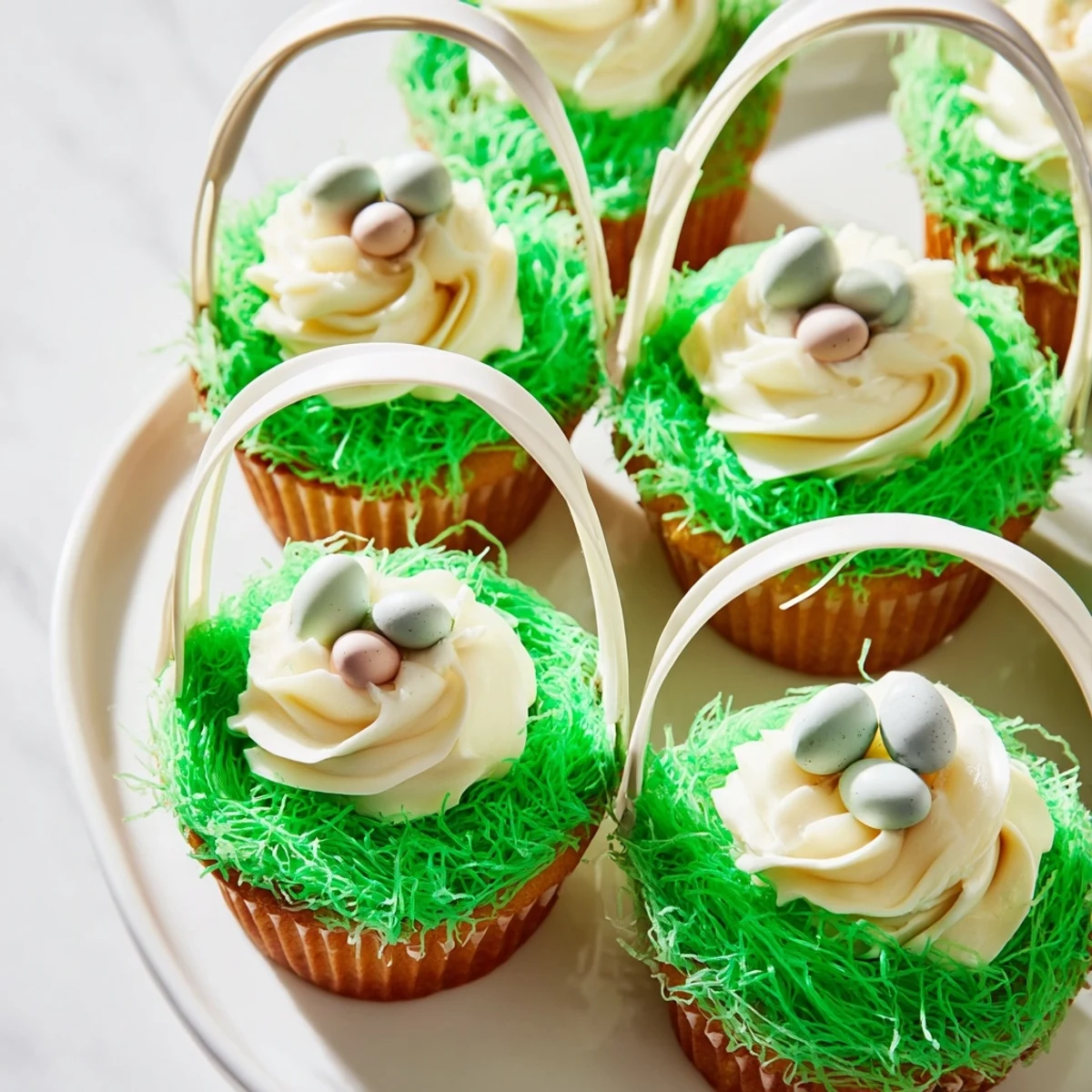 A close view of Easter Basket Cupcakes showing fluffy frosting and sugary coconut grass.