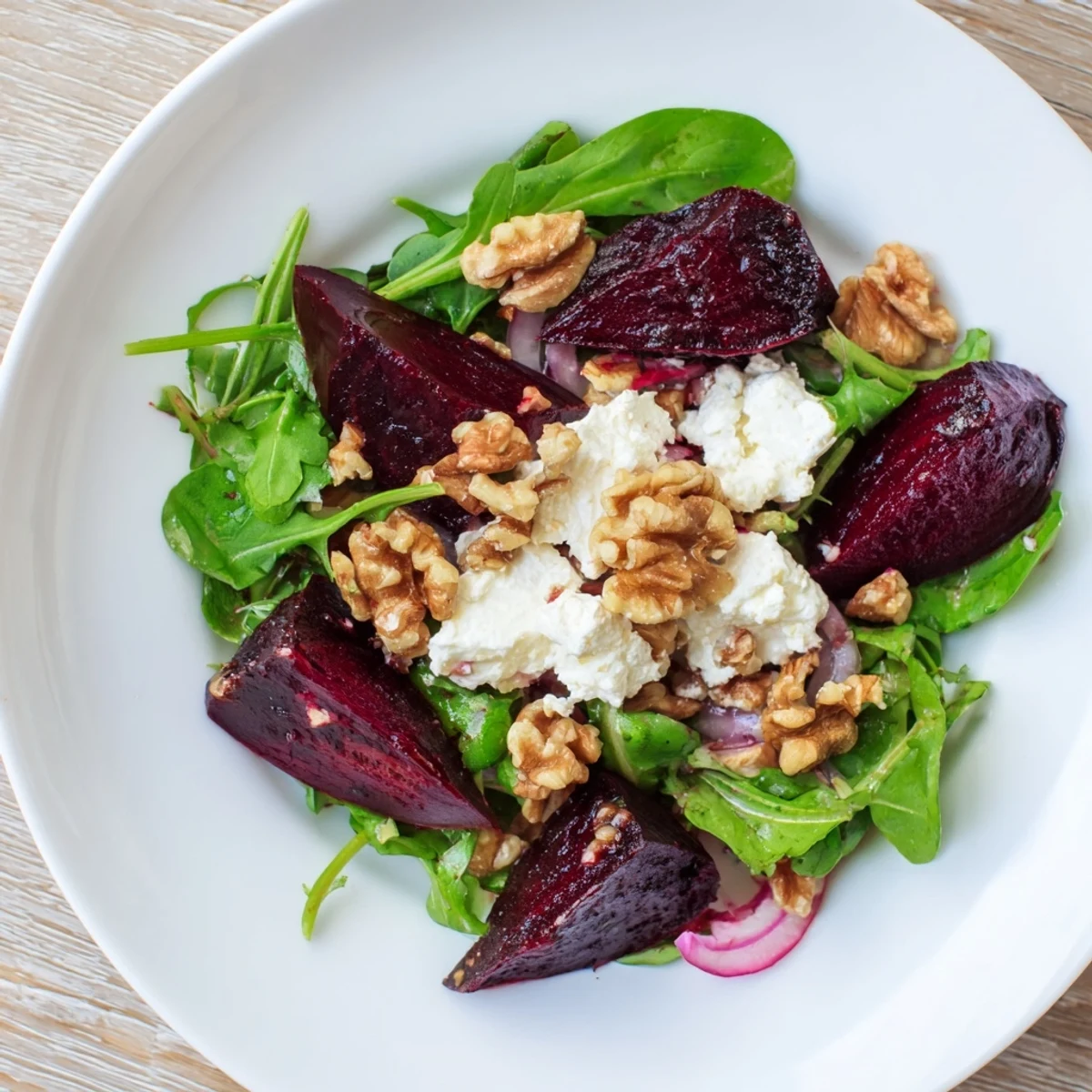 Roasted Beet Salad with jewel-toned beets, arugula, red onion, and walnuts, finished with a bright honey-Dijon dressing.