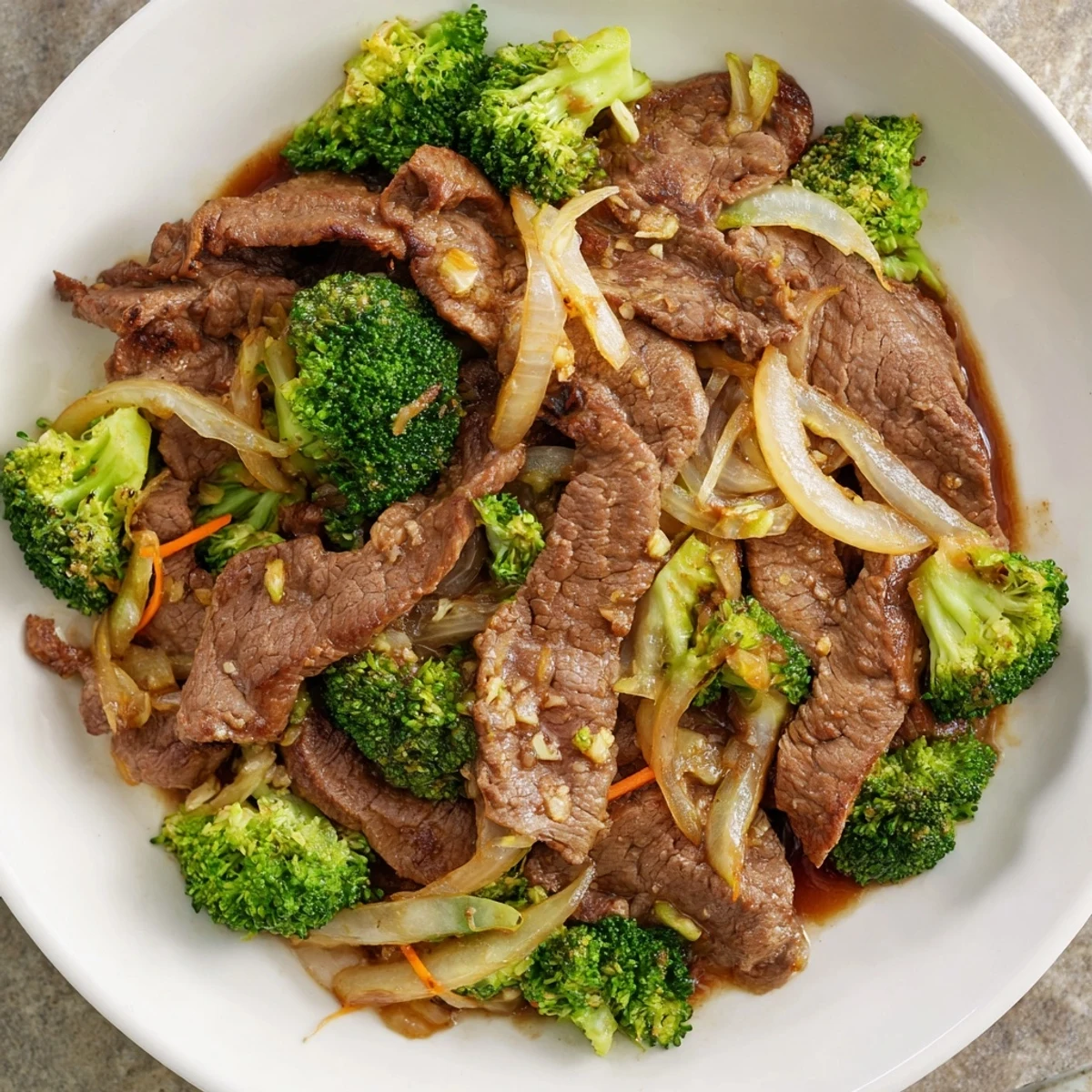 A close-up of Beef and Broccoli Stir Fry with Ginger Soy Sauce on a plate, showing tender beef and crisp broccoli coated in glossy sauce.
