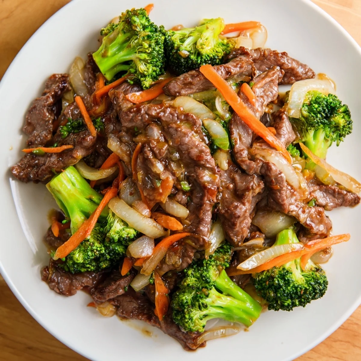 Freshly cooked Beef and Broccoli Stir Fry with Ginger Soy Sauce in a wok, highlighting vibrant green broccoli and savory brown sauce.