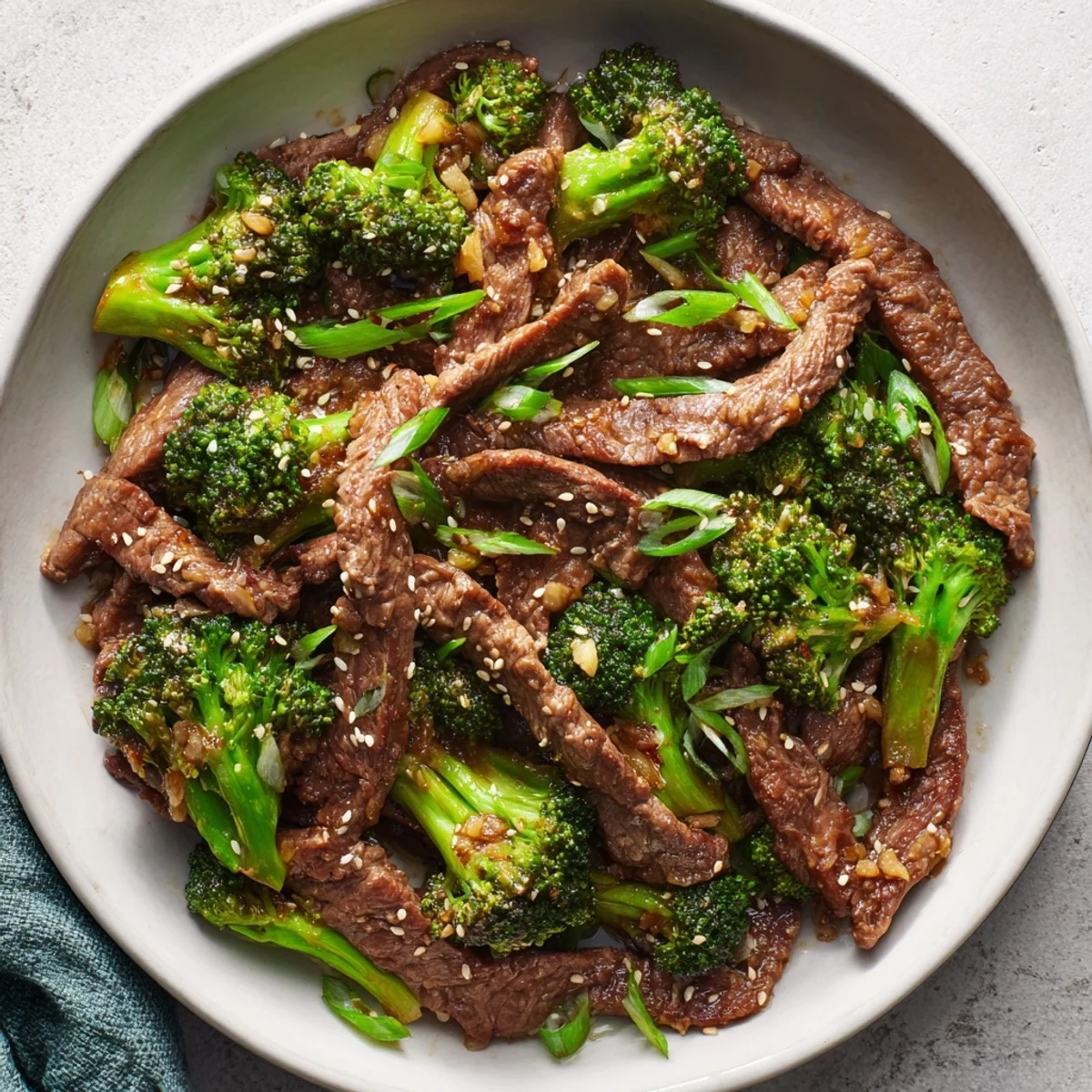 Tender beef strips and crisp broccoli florets coated in glossy ginger soy sauce served over fluffy rice in the Beef and Broccoli Stir Fry with Ginger Soy Sauce.