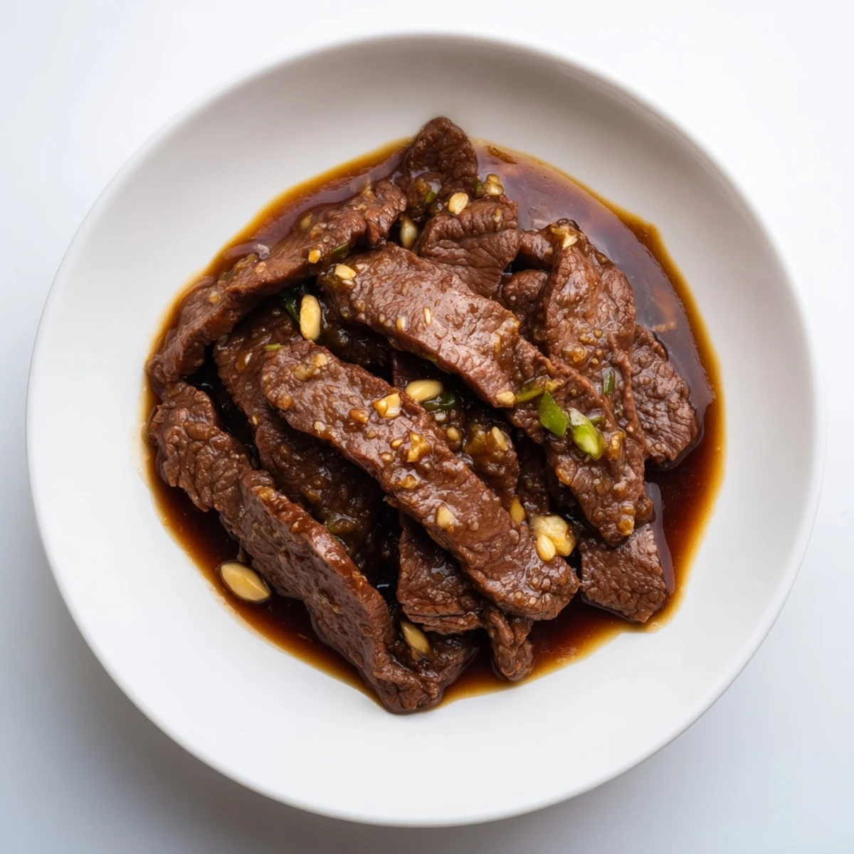 Tender beef strips glazed in a rich, garlicky sauce from the Ultimate Slow Cooker Mongolian Beef recipe.