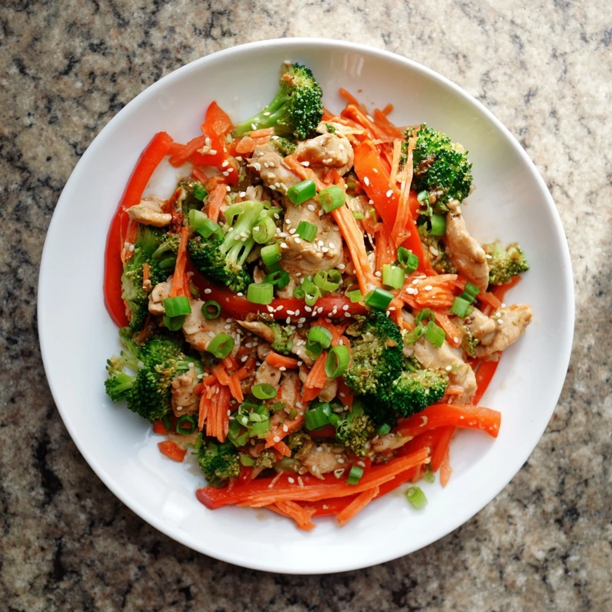 Colorful skillet of lean ground turkey and fresh broccoli tossed in a savory soy sesame glaze, garnished with green onion slices and sesame seeds.