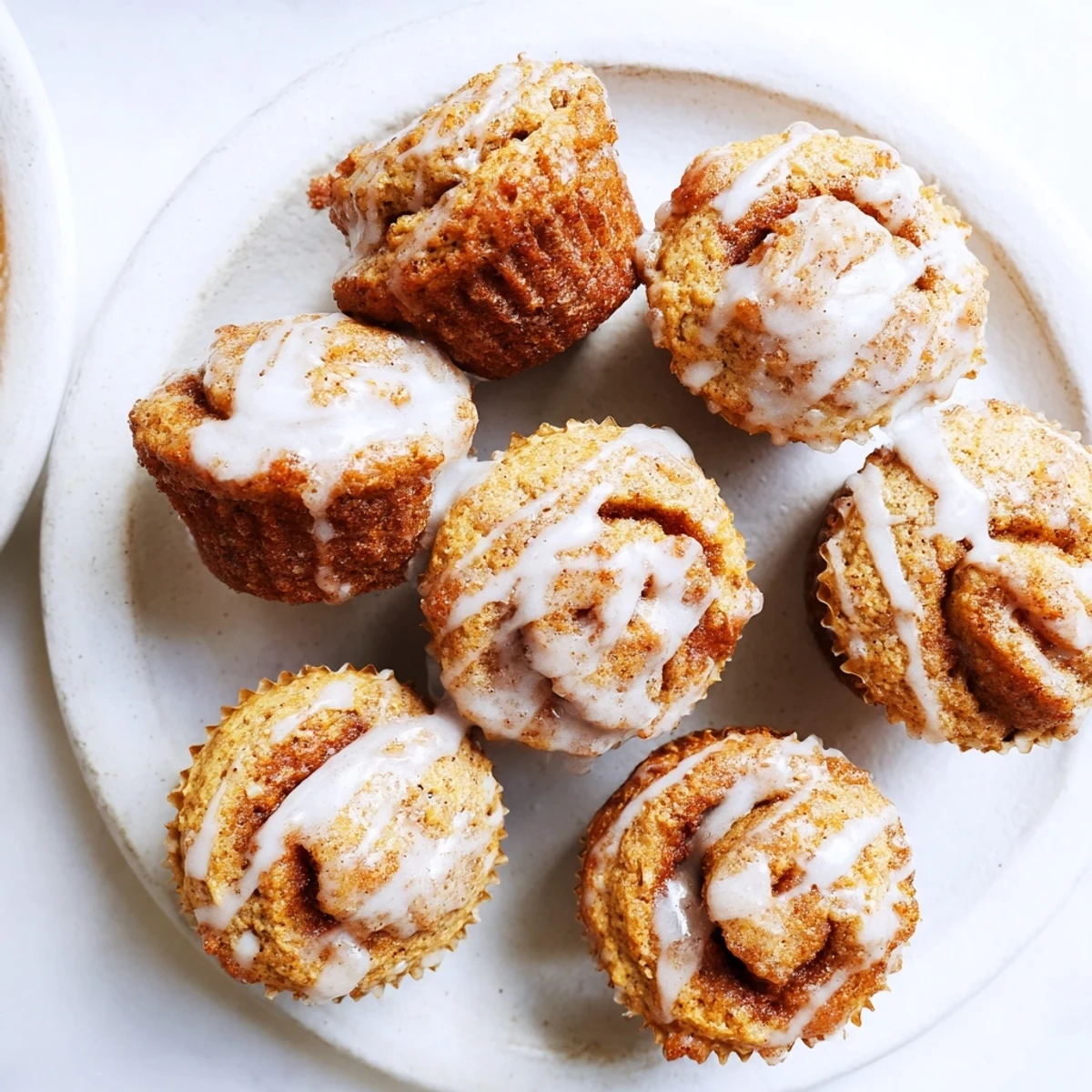 Fluffy high protein muffins swirled with warm cinnamon sugar and glazed with vanilla drizzle