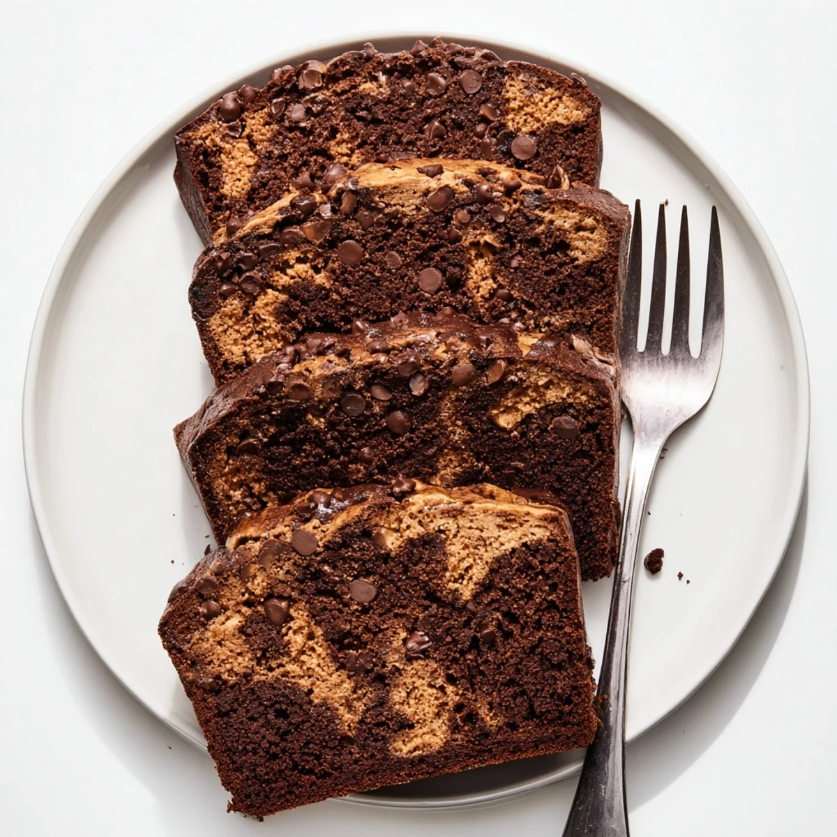 Slice of chocolate peanut butter banana bread showing melted chocolate chips and creamy marble layers inside