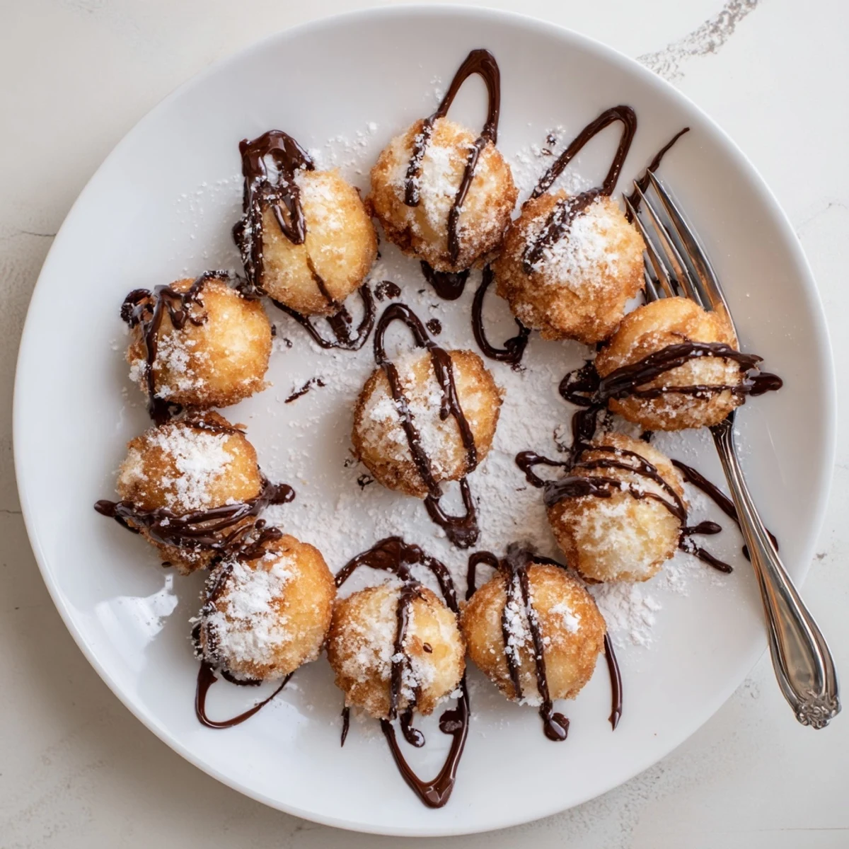 Golden deep fried marshmallows with crispy exterior and gooey center dusted with powdered sugar
