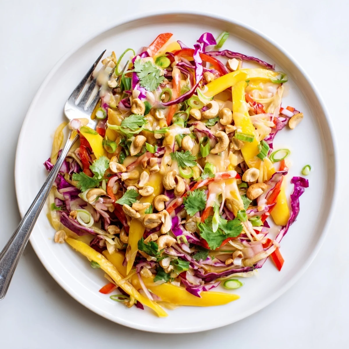 Refreshing mango slaw featuring crisp vegetables and vibrant tropical fruit in a serving dish