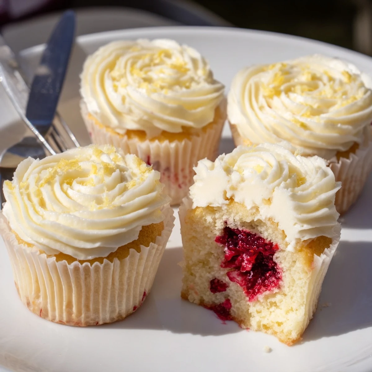 Fresh lemon cupcakes filled with tart raspberry preserves and swirled with creamy lemon buttercream