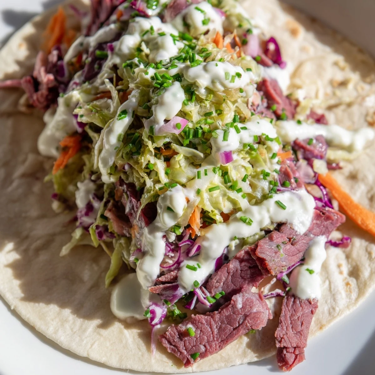 Warm flour tortilla filled with savory corned beef and crisp cabbage slaw drizzled with horseradish cream sauce
