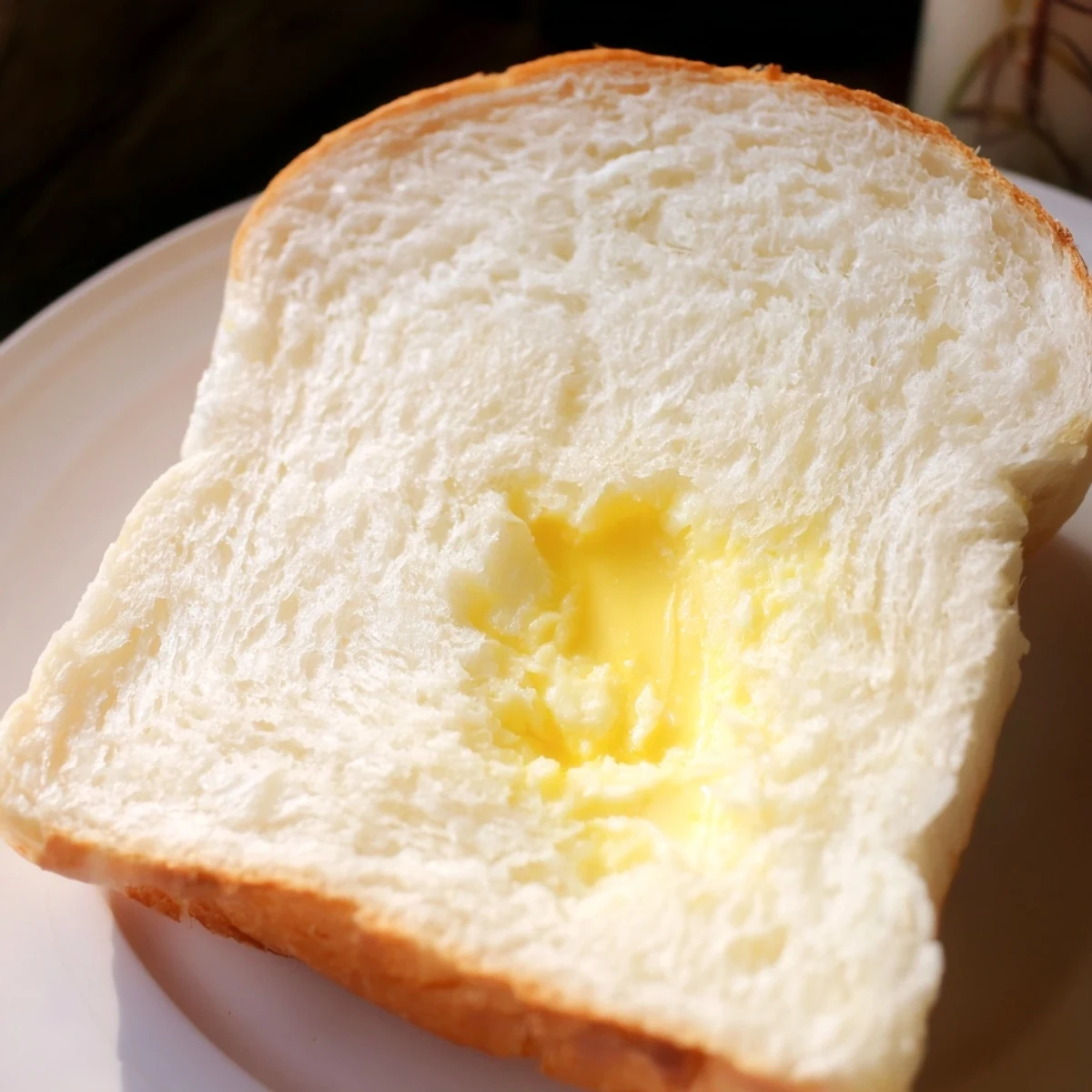 Two freshly baked loaves of Amish white bread cooling on wire rack ready for slicing