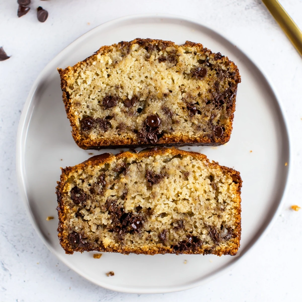 Freshly baked chocolate chip banana bread cooling on wire rack ready to slice
