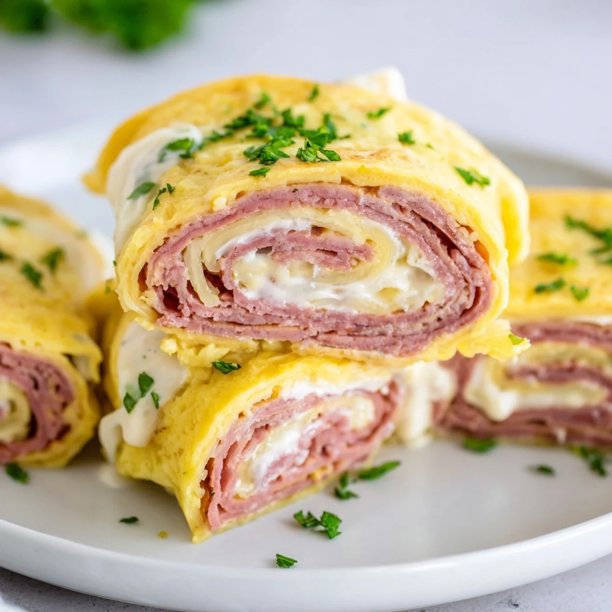 Golden low carb Reuben egg roll ups stuffed with corned beef and melted Swiss cheese on a white plate