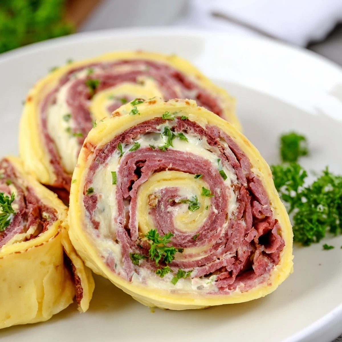 Tender low carb Reuben egg roll ups with tangy sauerkraut and creamy dressing, sliced and ready to serve