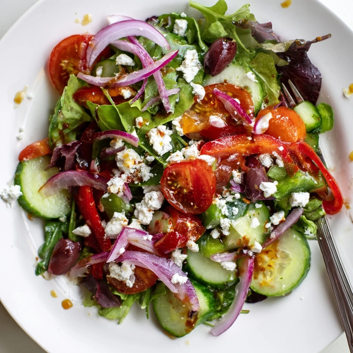 Bright Fresh Salad Recipe tossed in olive oil, feta, and pepper