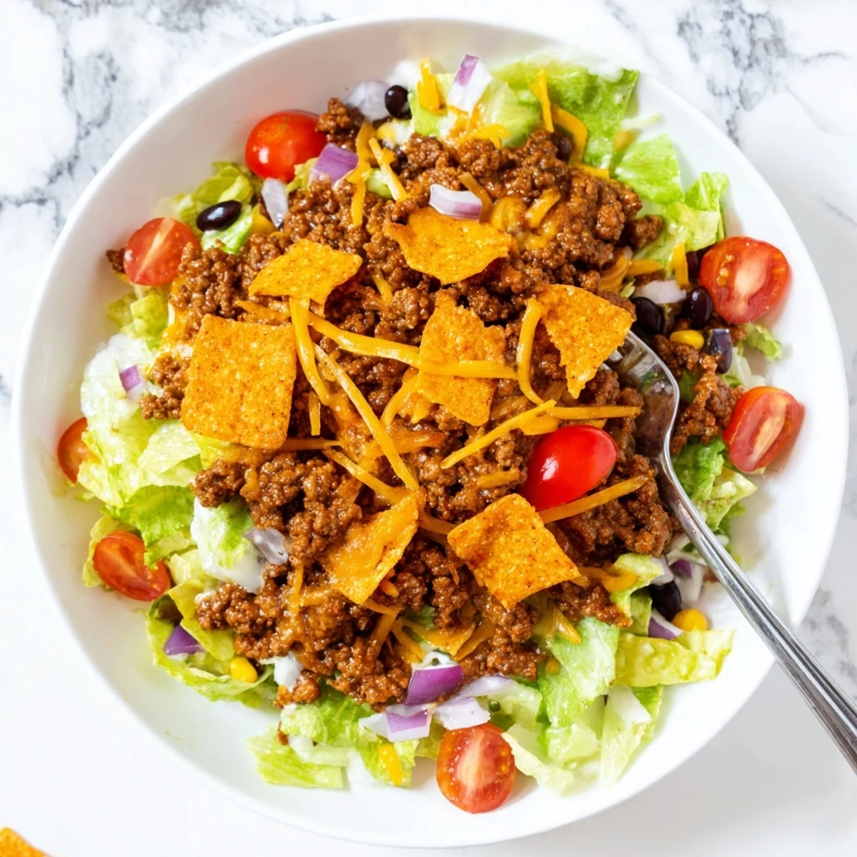 Simple Doritos Taco Salad piled high with crunchy chips and zesty beef