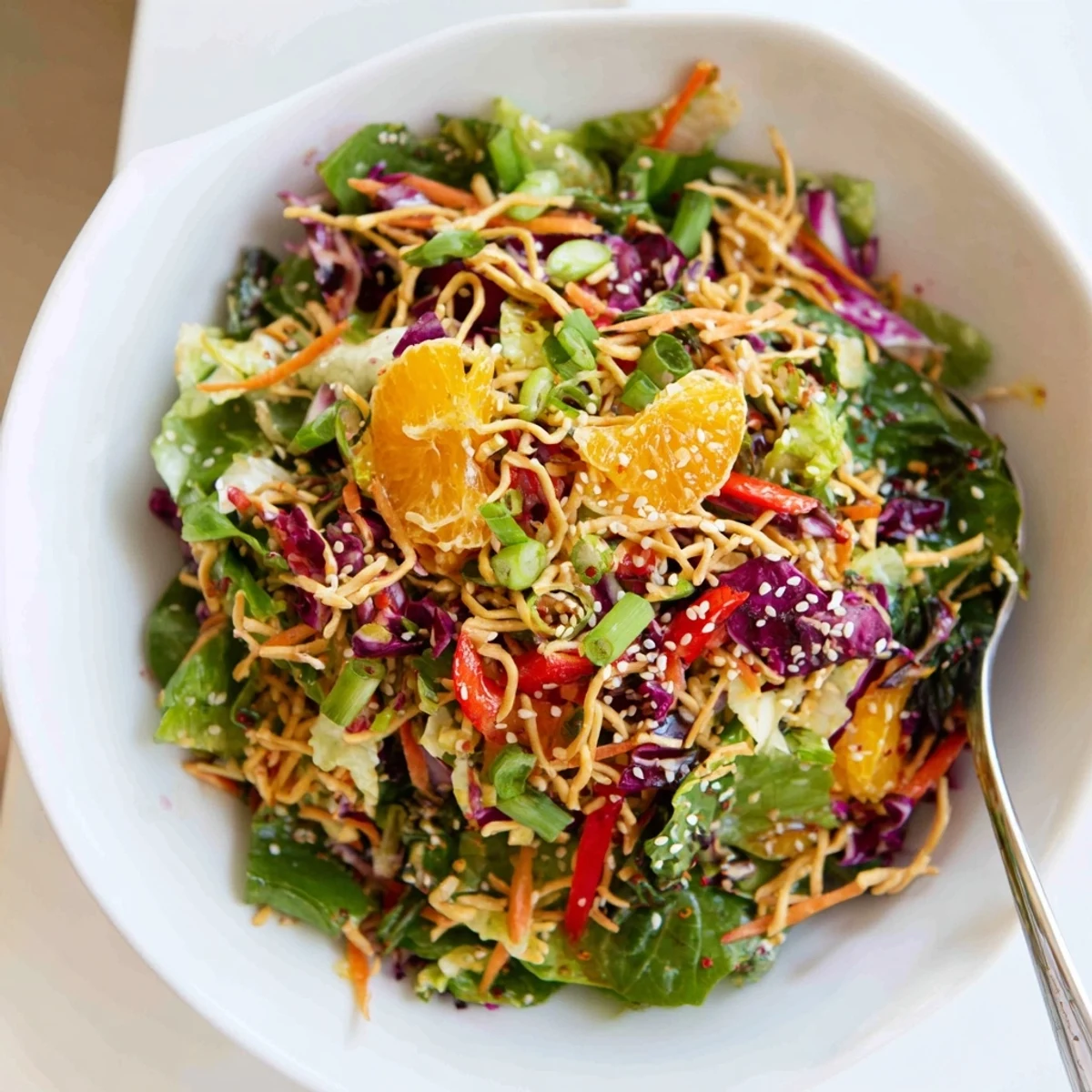 Golden sesame crunch tops a vivid Mandarin Sesame Crunch Salad with juicy orange segments and crisp vegetables.