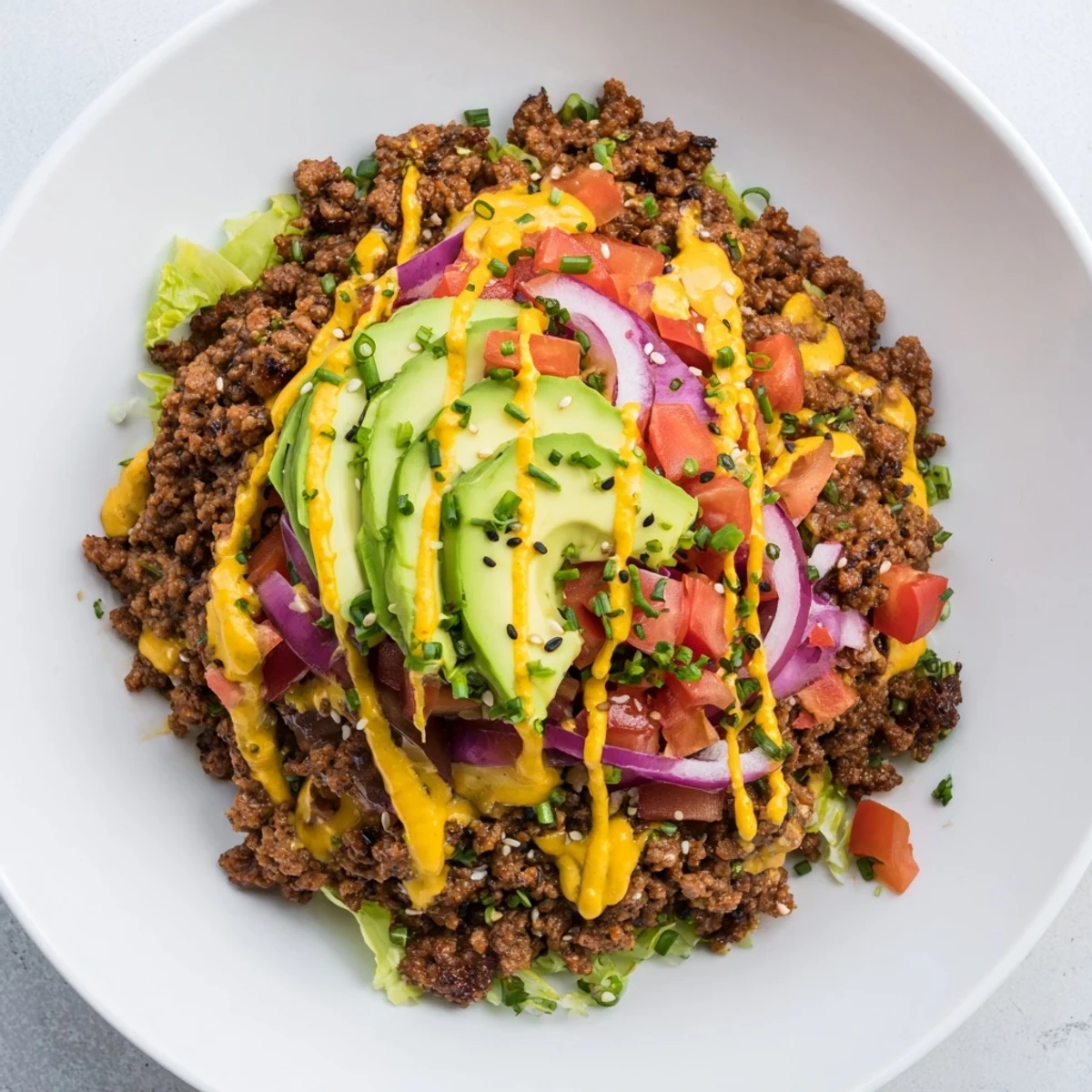 Juicy burger bowls loaded with seasoned beef, melted cheddar, and fresh vegetables