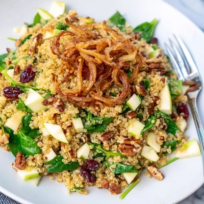 Fluffy quinoa tossed with diced apples spinach and tangy honey mustard dressing served fresh